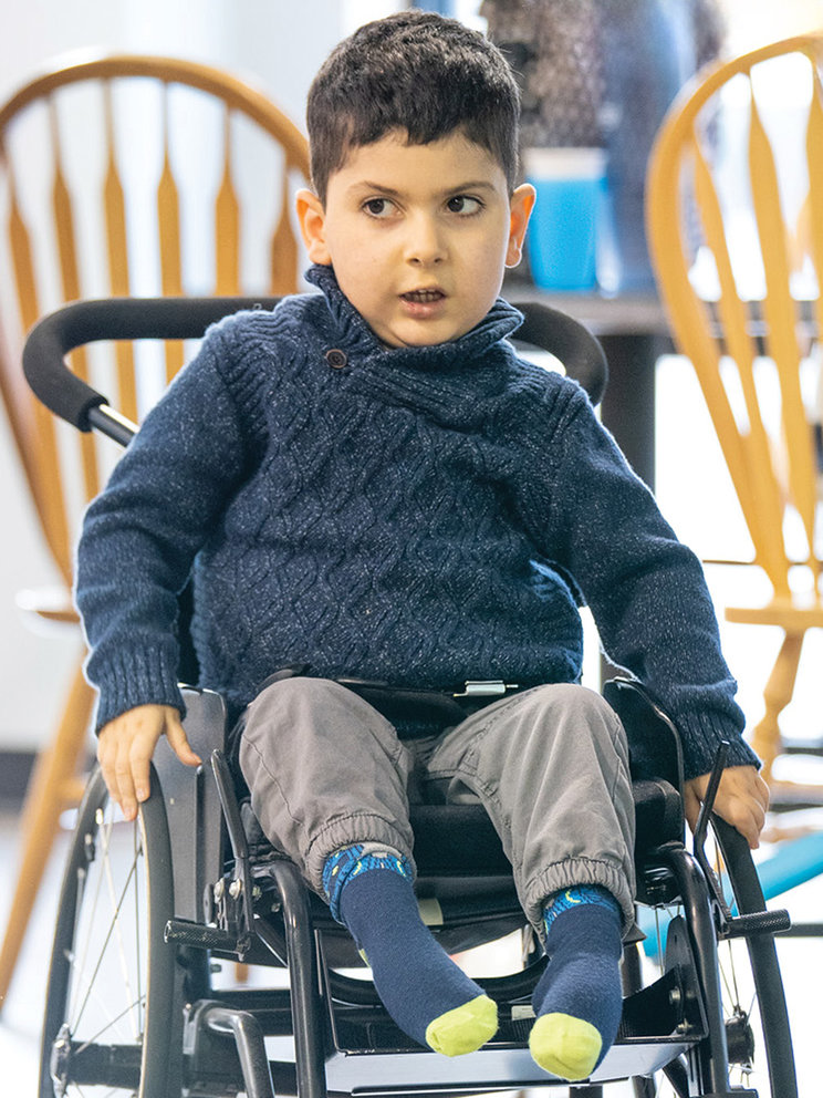 Donovan at 4 years old, pushing himself in his wheelchair